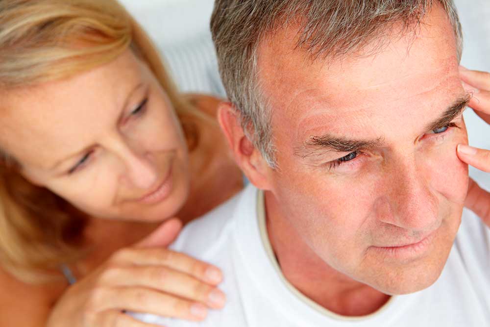 anxious man comforted by wife