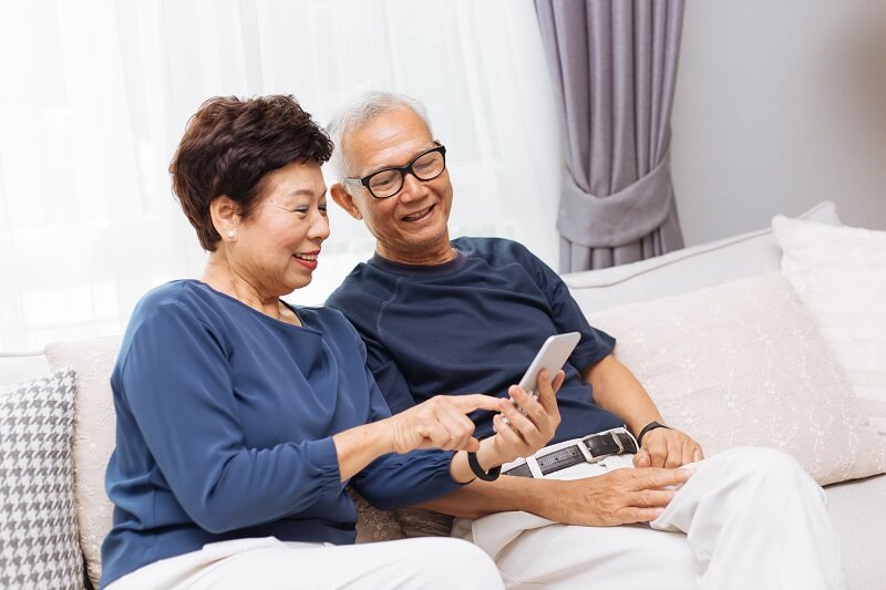 elderly asian couple on phone